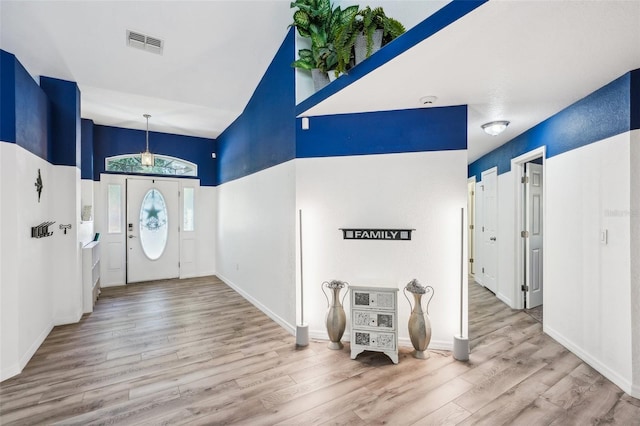 entrance foyer featuring visible vents, baseboards, and wood finished floors