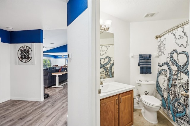 full bathroom featuring visible vents, toilet, vanity, wood finished floors, and baseboards