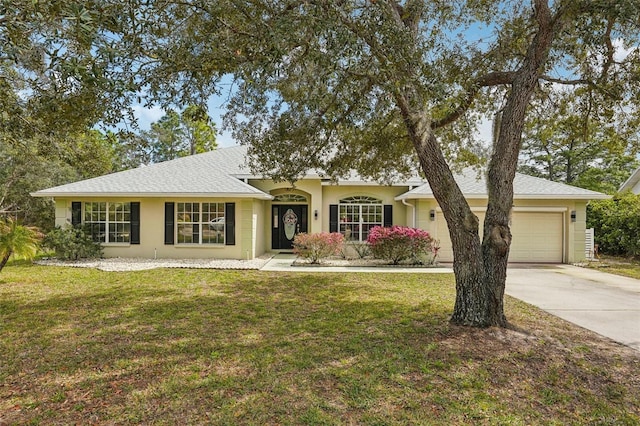 single story home featuring a garage, a front lawn, concrete driveway, and stucco siding