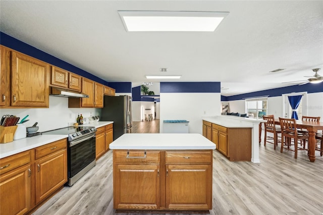 13 Witch Hazel Ct, Homosassa, FL 34446 - kitchen with stainless steel appliances, under cabinet range hood, and brown cabinetry