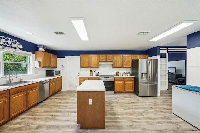 13 Witch Hazel Ct, Homosassa, FL 34446 - kitchen featuring stainless steel appliances, a sink, light wood-type flooring, and under cabinet range hood
