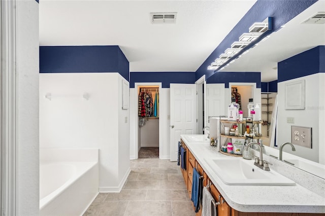 13 Witch Hazel Ct, Homosassa, FL 34446 - full bathroom featuring baseboards, a bath, tile patterned floors, and double vanity