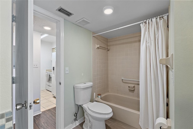 bathroom featuring shower / bath combo, wood finished floors, and visible vents