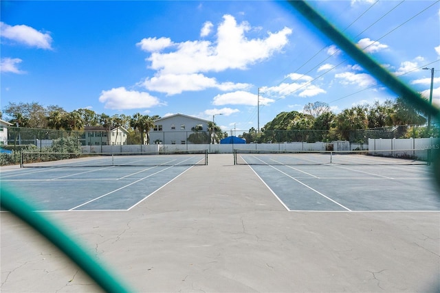 view of sport court featuring fence