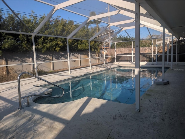 view of pool featuring a patio, a fenced backyard, a fenced in pool, and a lanai