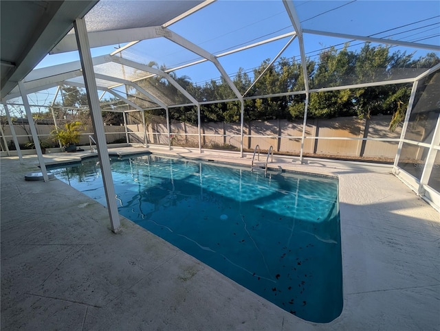 view of swimming pool featuring a lanai, a fenced backyard, a fenced in pool, and a patio