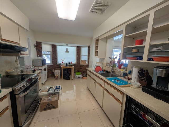 kitchen featuring light tile patterned floors, stainless steel appliances, open shelves, light countertops, and visible vents