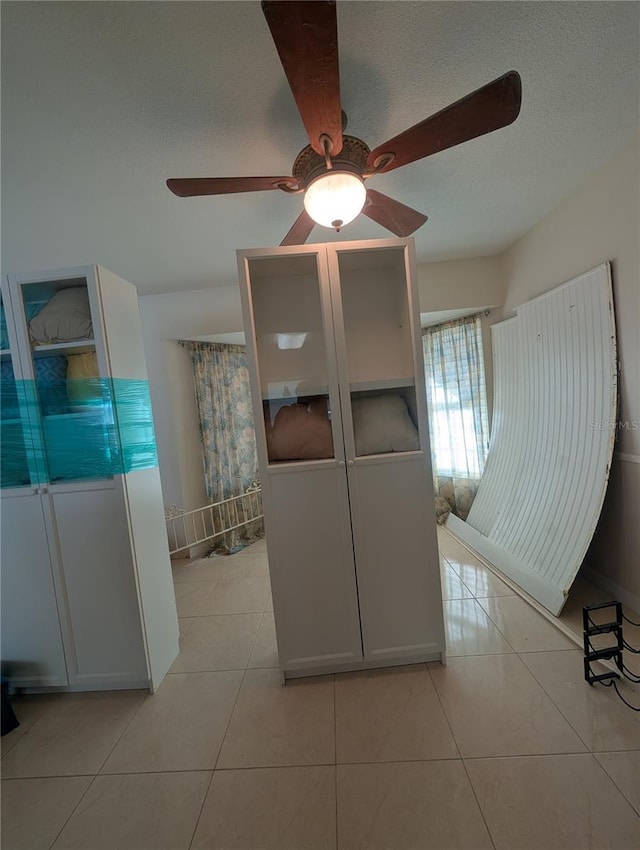 interior space featuring light tile patterned floors and a textured ceiling