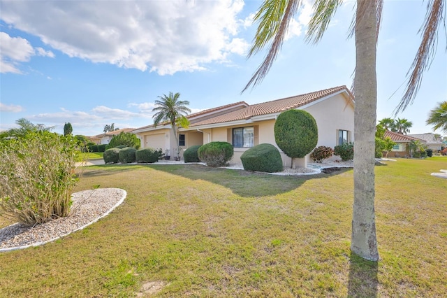 view of front of house featuring a front lawn, an attached garage, a tile roof, and stucco siding