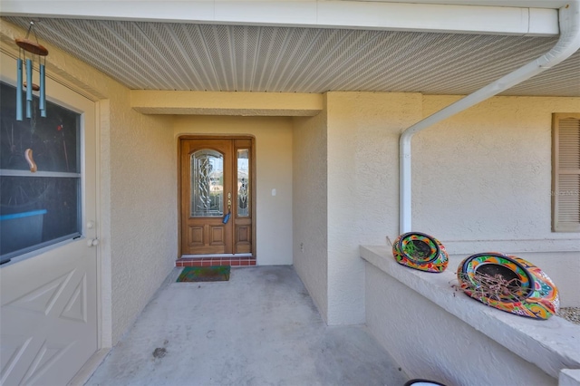 view of exterior entry with stucco siding