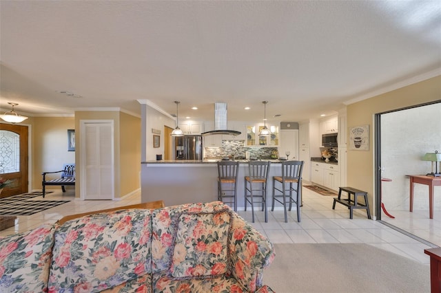 living area featuring light tile patterned floors, baseboards, ornamental molding, and recessed lighting