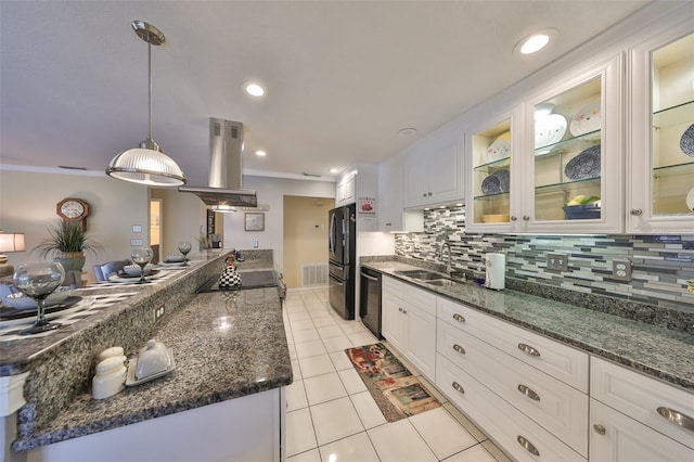 kitchen with island exhaust hood, tasteful backsplash, white cabinetry, a sink, and black appliances