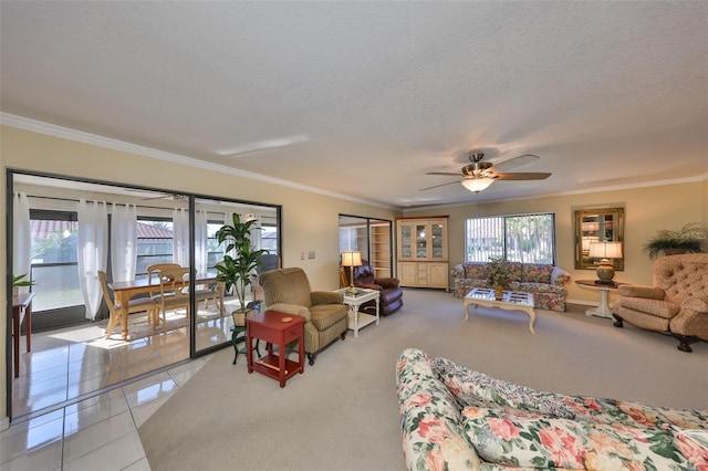 living area featuring a wealth of natural light, crown molding, and light tile patterned floors