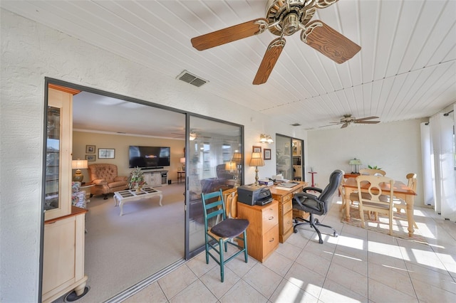 interior space with ceiling fan and visible vents