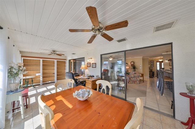 dining area with light tile patterned floors, wood ceiling, and visible vents