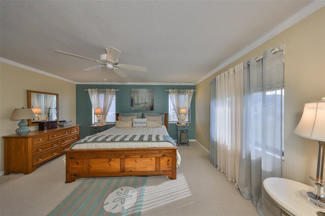 bedroom featuring a ceiling fan, light carpet, and crown molding