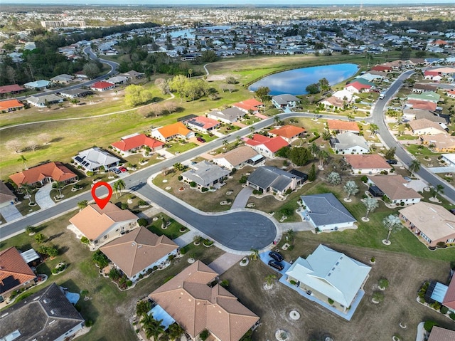 birds eye view of property featuring a water view and a residential view