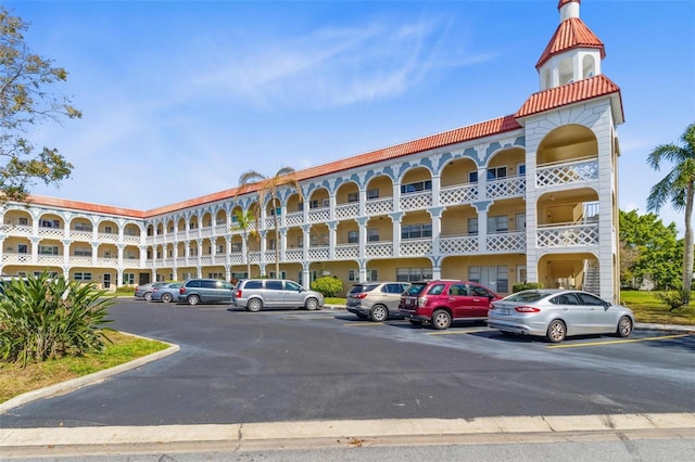 view of building exterior featuring uncovered parking