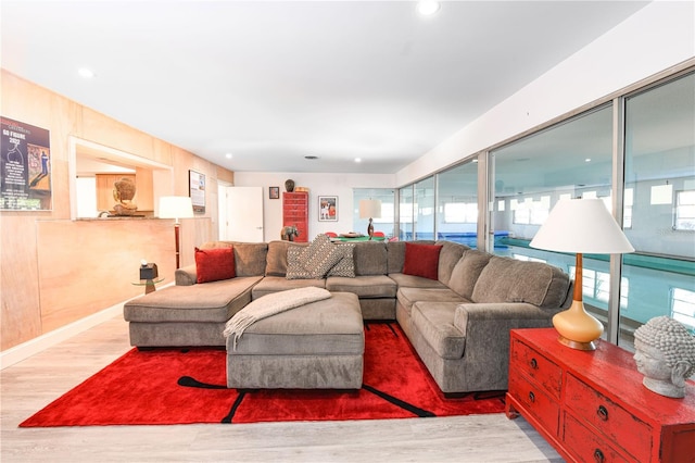 living area with wood finished floors and recessed lighting