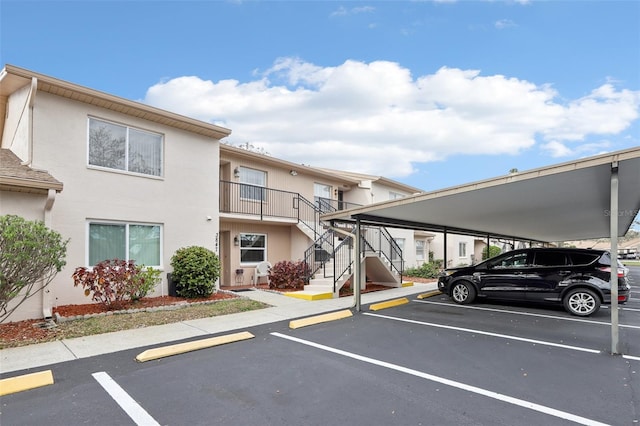 partially covered parking lot featuring stairs