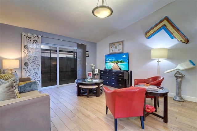 living room featuring baseboards, vaulted ceiling, and wood finished floors