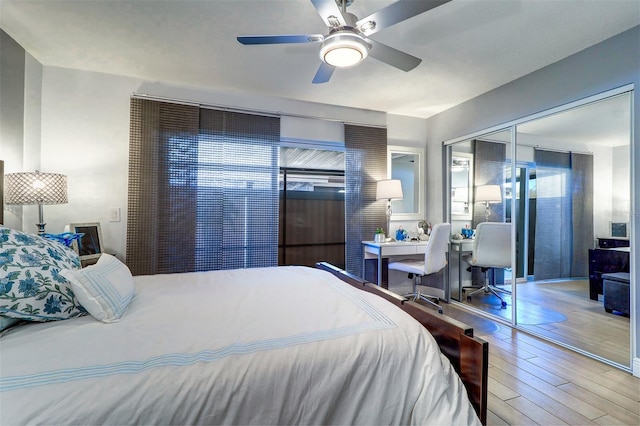 bedroom with a closet, wood finished floors, and a ceiling fan