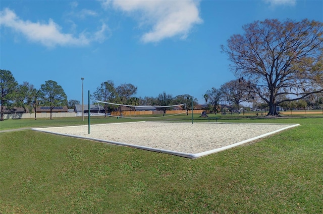 view of property's community with a yard and volleyball court