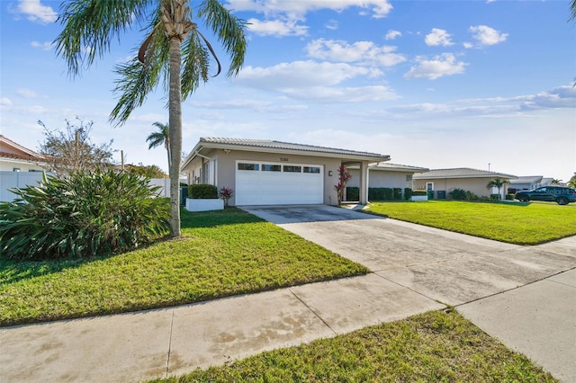 single story home featuring a tile roof, stucco siding, concrete driveway, an attached garage, and a front yard