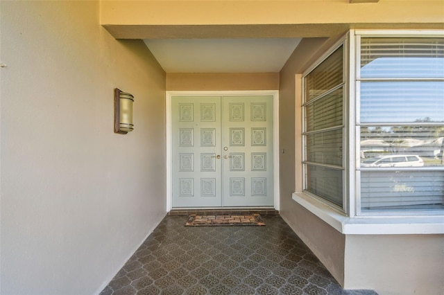 entrance to property with stucco siding