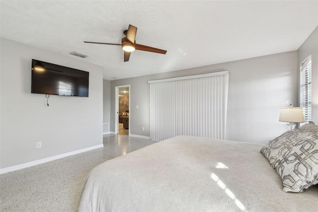 bedroom with visible vents, ceiling fan, a textured ceiling, baseboards, and speckled floor