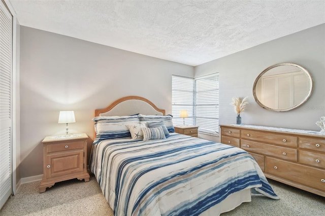 bedroom featuring baseboards and a textured ceiling