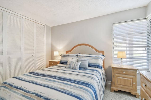 bedroom with a closet, baseboards, and a textured ceiling