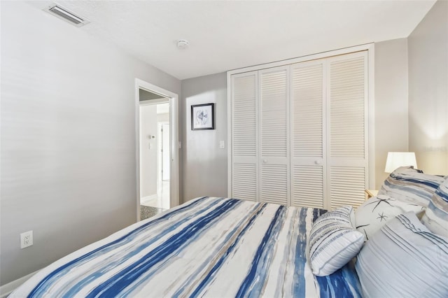 bedroom featuring a closet and visible vents