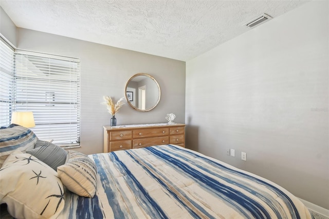 bedroom with visible vents and a textured ceiling