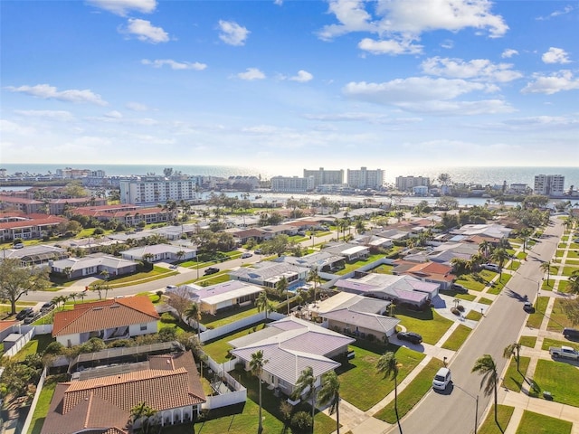 drone / aerial view featuring a water view and a view of city