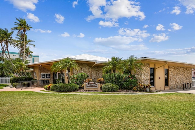 view of front of home with a front lawn and fence