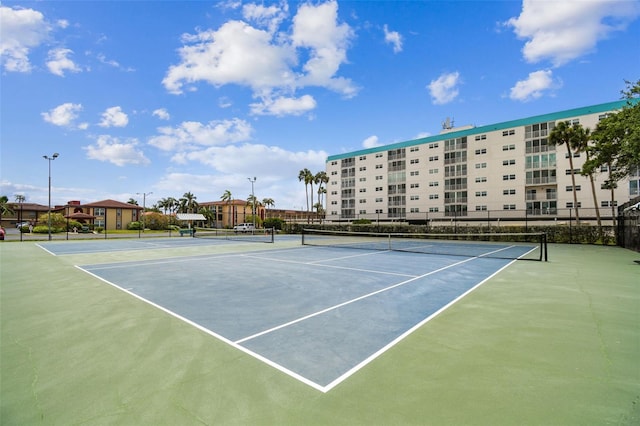 view of sport court featuring fence