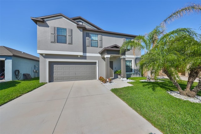 view of front of home featuring driveway, a front lawn, an attached garage, and stucco siding