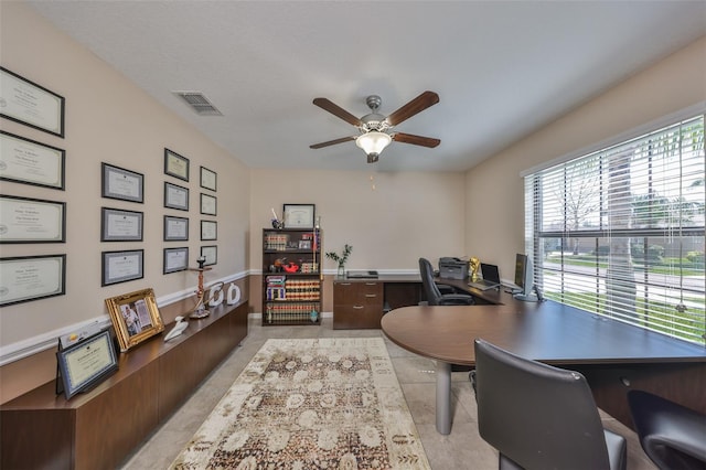 office area featuring light tile patterned floors, visible vents, and a ceiling fan