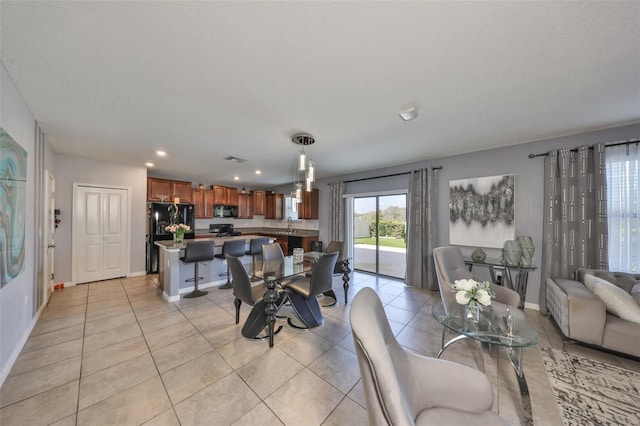 dining room featuring recessed lighting, baseboards, and light tile patterned floors