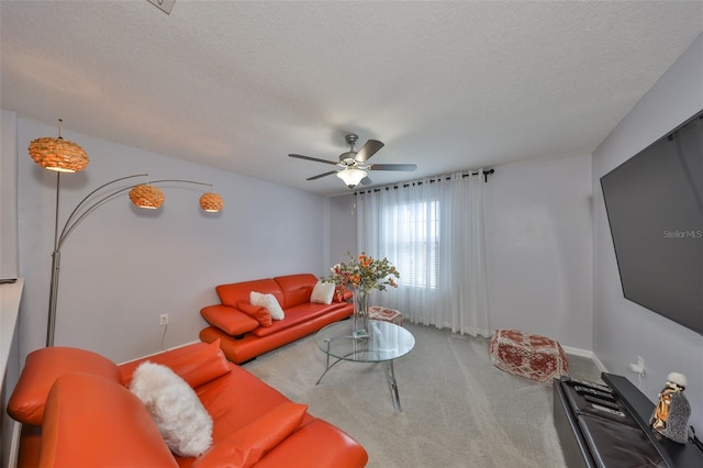 carpeted living area featuring a textured ceiling and a ceiling fan