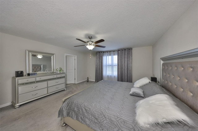 bedroom with a textured ceiling, baseboards, and light colored carpet