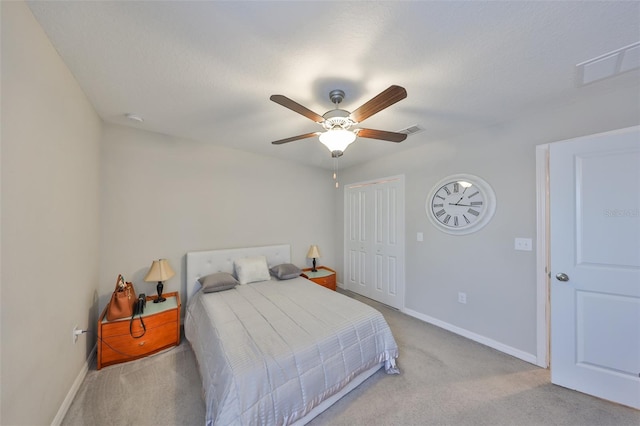 bedroom featuring light carpet, a closet, visible vents, and baseboards