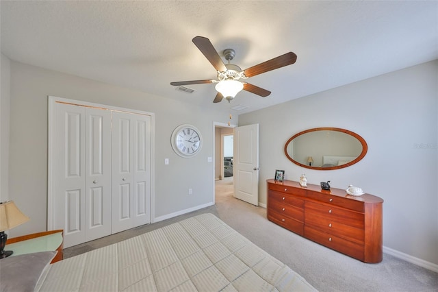 bedroom featuring visible vents, baseboards, a ceiling fan, carpet flooring, and a closet