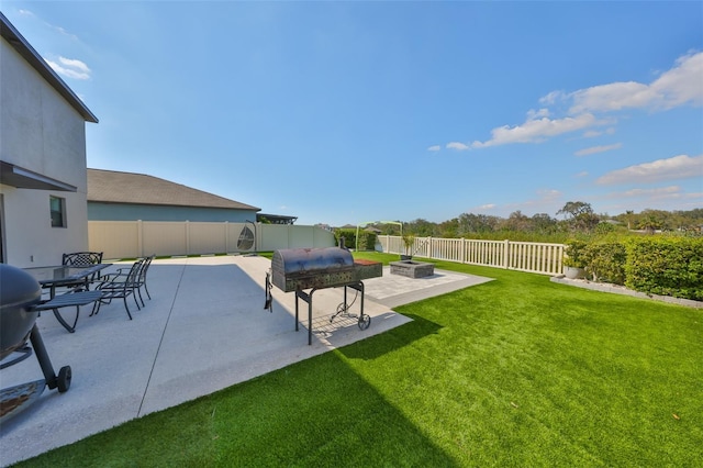 view of yard with a fire pit, a patio, and a fenced backyard