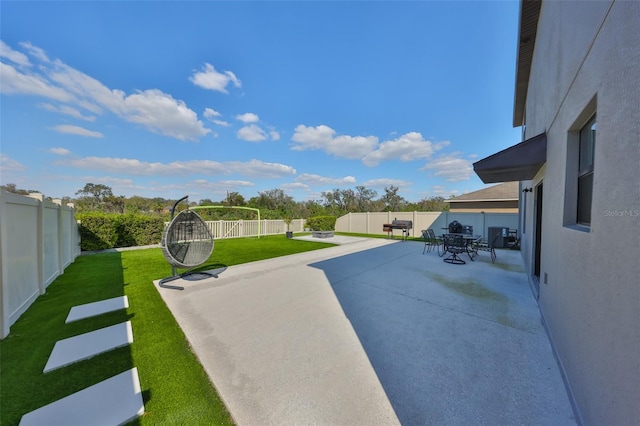 view of patio featuring outdoor dining space and a fenced backyard