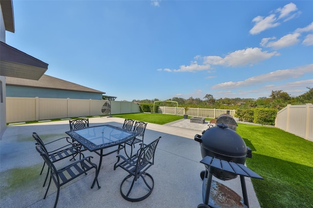 view of patio / terrace featuring outdoor dining space, a fenced backyard, a fire pit, and area for grilling