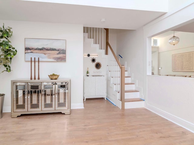 stairs with baseboards and wood finished floors