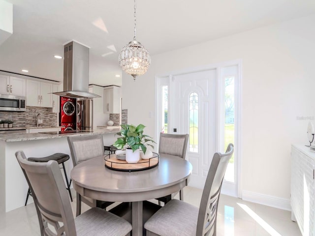 dining room with baseboards, light tile patterned floors, a notable chandelier, and recessed lighting