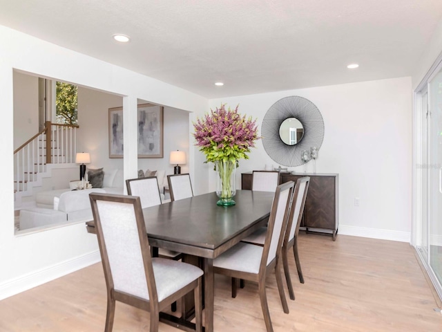 dining area featuring light wood-type flooring, baseboards, and recessed lighting